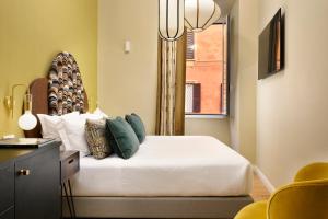 a bedroom with a bed with a window and a chandelier at Velantia Vaticano - Guesthouse in Rome