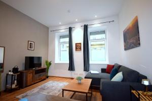a living room with a couch and a tv at Cozy Apartments in Central Location with Free Parking on Availability in Vienna