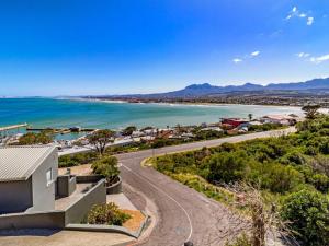 an aerial view of a house and the ocean at 5 Suikerbossie in Gordonʼs Bay +7 photos