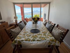 a dining room with a table and chairs with a view at 5 Suikerbossie in Gordonʼs Bay