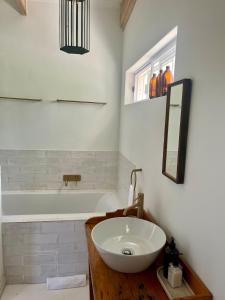 a bathroom with a sink and a bath tub at Jonkershuis Farm Retreat in Heidelberg