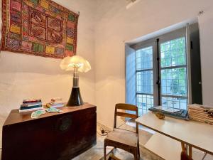 a room with a desk and a table with a lamp at Suite tolila te house of medina of tunis in Tunis +26 photos