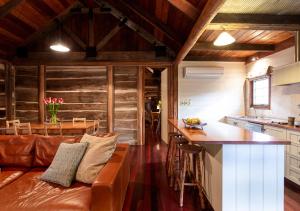 a living room with a couch and a kitchen at 1860 Luxury Accommodation in Beechworth