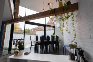 a dining room with a table and chairs at Townhouse Tongeren Center 275m2, 10p - Featured in Designbook in Tongeren