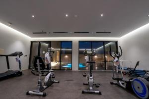 a gym with exercise equipment in a building at Jovan suites apartment in AlUla