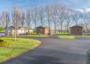 a street with houses and trees in a subdivision at Cleveland Hills View Holiday Park in Middleton upon Leven