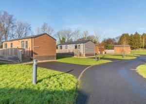 a road leading to a home and a house at Cleveland Hills View Holiday Park in Middleton upon Leven +30 photos