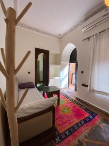 a bedroom with a bed and a tree in it at Riad Musa in Marrakesh