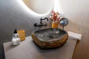 a bathroom with a large rock sink on a counter at El rincón de rosina in Sequera de Fresno +13 photos