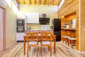 a kitchen with a wooden table and chairs at El rincón de rosina in Sequera de Fresno