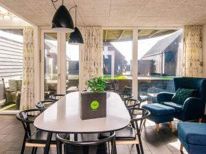 a dining room with a table and chairs at Exclusive Golf View Retreat in Rømø Kirkeby +40 photos