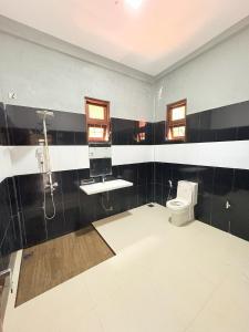 a bathroom with a shower and a toilet and a sink at Sthupa Horizon in Anuradhapura +14 photos