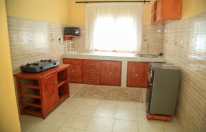 a kitchen with a refrigerator and a window at The Hidden Paradise in Mombasa