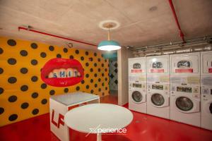 a laundry room with a mouth on the wall at Secrt Sabana 2BR · Skyline View · High Floor · Pool & Gym · Apt 2810 in San José
