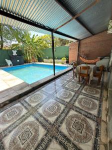 a patio with a pool and a table and chairs at YBVerde in Yerba Buena