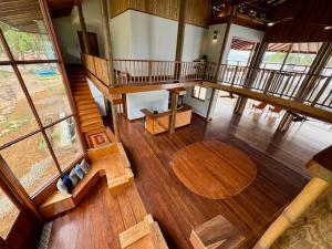 an overhead view of a living room with a wooden floor at Bocas Beachfront Lodge Spacious Corner King Suite Ocean View Sand Level in Bocas del Toro