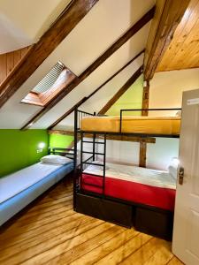 a room with three bunk beds in a attic at Hostel Vagabond in Sarajevo