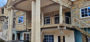 a building with a balcony on the side of it at GV Homes and Apartments in Gbawe
