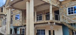 a building with a balcony on the side of it at GV Homes and Apartments in Gbawe
