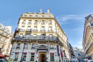 
a large building with a clock on the front of it at Normandy Le Chantier in Paris
