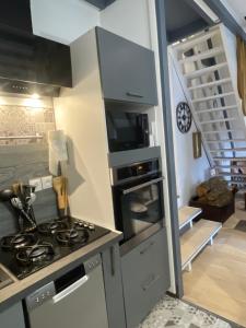 a kitchen with a stove and a stove top oven at L'armorique in Saint Die