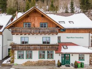 an image of a house in the snow at Apparthaus Sonnenberg in Haus im Ennstal