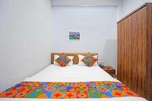 une chambre avec un lit avec une couette colorée dans l'établissement FabHotel Super Corridor, 