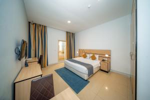 a hotel room with a bed and a television at City Stay Grand Hotel Apartments - Al Barsha in Dubai +27 photos