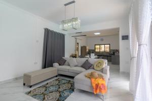 a living room with a couch and a chair at Peaceful Villa by Oceanaxe Holidays in Grand Baie +14 photos