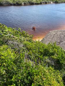 a group of people in a boat in the water at Chalé Portal das Lagoas in Santo Amaro
