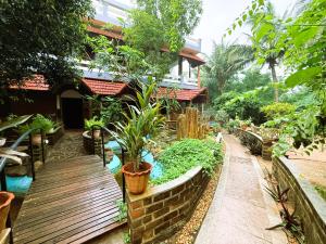 a garden with a wooden bench and plants at Greens Heritage Resort with Swimming Pool in Auroville +67 photos