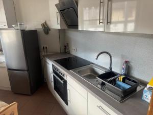 a kitchen with a sink and a refrigerator at LandgasthofOrleshausen in Büdingen