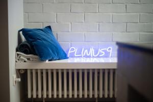 a blue pillow sitting on top of a radiator at Townhouse Tongeren Center 275m2, 10p - Featured in Designbook in Tongeren