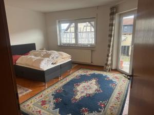 a bedroom with a bed and a rug at LandgasthofOrleshausen in Büdingen
