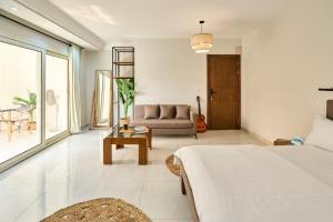 a living room with a bed and a couch at Jira Inn Hotel - چيران in Cairo +151 photos