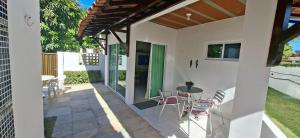 a patio with a table and chairs on it at Casa em Porto de Galinhas - PRIVÊ DAS ONDAS in Porto De Galinhas