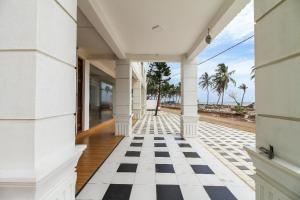 ein offener Flur eines Hauses mit Schachbrettmusterboden in der Unterkunft Royal Oshin Hotel in Wadduwa