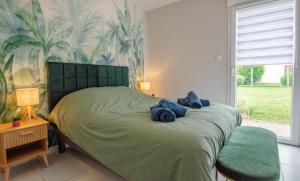 a bedroom with a bed with blue stuffed animals on it at Le Fairway in Bréviandes