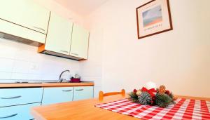 a kitchen with a table with christmas decorations on it at a 200m dai mercatini TERRAZZO PANORAMICO LOFT in Centro Storico-Stazione in Trento +52 photos