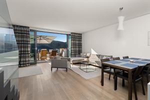 a living room with a table and a dining room at Park Hill Residences in Rabac