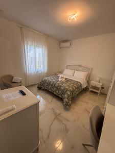 a bedroom with a bed with a cat sitting on it at a&g partenope in Monterusciello