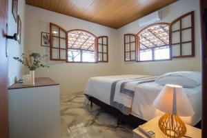 Ένα ή περισσότερα κρεβάτια σε δωμάτιο στο Carcará Vacation Homes