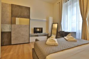 een slaapkamer met een bed met twee handdoeken erop bij Morina Rooms in Trieste