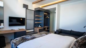 a bedroom with a large bed and a tv at Kaf Mount Erciyes in Hacılar