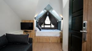 a small bedroom with a bed and a window at Kaf Mount Erciyes in Hacılar