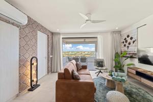 a living room with a couch and a table at Coral Whisper - Aquamarine 8 in Willemstad