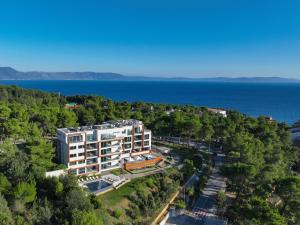 an aerial view of a building with the ocean in the background at Park Hill Residences in Rabac