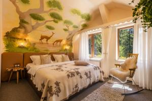a bedroom with a tree mural on the wall at Kuker Hut - Хижа Кукер in Sofia