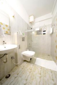 a bathroom with a sink and a toilet and a shower at Hotel Serenity La Vista in Hyderabad
