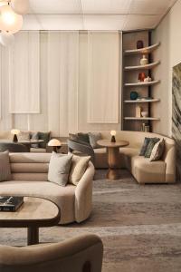 a living room with two couches and a table at The Berkeley, Maybourne in London